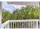 Balcony view overlooking lush greenery and blue skies at 721 Laurel Bay Cir, New Smyrna Beach, FL 32169