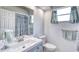 Bright bathroom with a vanity, mirror, and a shower/tub with a decorative curtain at 721 Laurel Bay Cir, New Smyrna Beach, FL 32169
