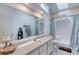 Bathroom featuring a large mirror, neutral countertops, and a walk-in shower at 721 Laurel Bay Cir, New Smyrna Beach, FL 32169