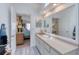 Bathroom vanity featuring a large mirror and a view into an adjacent bedroom at 721 Laurel Bay Cir, New Smyrna Beach, FL 32169