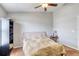 Neutral bedroom with ceiling fan, window, carpet, and side tables at 721 Laurel Bay Cir, New Smyrna Beach, FL 32169