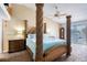 Stately primary bedroom featuring sculpted bedposts, light blue bedding, and outdoor views at 721 Laurel Bay Cir, New Smyrna Beach, FL 32169