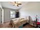Neutral bedroom with ceiling fan, window, carpet, and side tables at 721 Laurel Bay Cir, New Smyrna Beach, FL 32169