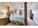 Stately primary bedroom featuring sculpted bedposts and light blue bedding at 721 Laurel Bay Cir, New Smyrna Beach, FL 32169