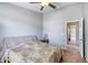 Neutral bedroom with ceiling fan, window, carpet, and side tables at 721 Laurel Bay Cir, New Smyrna Beach, FL 32169