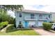 Charming blue townhouse with a cozy porch, well-maintained yard, and inviting curb appeal in a tranquil neighborhood at 721 Laurel Bay Cir, New Smyrna Beach, FL 32169