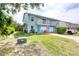 A lovely townhouse with a neatly kept lawn and a brick paved driveway leading to the garage at 721 Laurel Bay Cir, New Smyrna Beach, FL 32169