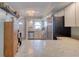 Bright kitchen featuring stainless steel appliances, light cabinets, and a pass-through to the living area at 721 Laurel Bay Cir, New Smyrna Beach, FL 32169