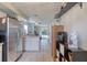 Spacious kitchen with stainless steel refrigerator and view to the dining and living area at 721 Laurel Bay Cir, New Smyrna Beach, FL 32169
