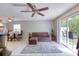 Living room featuring a sofa, dining table, and sliding glass doors to the backyard at 721 Laurel Bay Cir, New Smyrna Beach, FL 32169