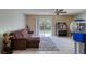 Living room with a large sofa, sliding glass doors to the backyard, and tiled flooring at 721 Laurel Bay Cir, New Smyrna Beach, FL 32169