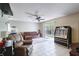 Bright living room featuring tile flooring, ceiling fan, and sliding glass doors leading to the outdoors at 721 Laurel Bay Cir, New Smyrna Beach, FL 32169