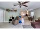 Bright living room featuring a sofa, table with chairs, and access to outdoor space at 721 Laurel Bay Cir, New Smyrna Beach, FL 32169
