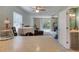 Open-concept living area with sliding doors, a dining table, and access to the half bathroom at 721 Laurel Bay Cir, New Smyrna Beach, FL 32169