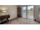 Inviting living area with neutral carpet, sliding glass doors, and outdoor views at 721 Laurel Bay Cir, New Smyrna Beach, FL 32169