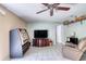 Relaxing living space with a TV, recliner, and nearby storage shelves at 721 Laurel Bay Cir, New Smyrna Beach, FL 32169