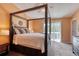 Bedroom featuring a dark wood frame bed with a slider to a balcony and an orange accent wall at 721 Laurel Bay Cir, New Smyrna Beach, FL 32169