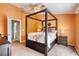 A bedroom featuring a dark wood frame bed, a ceiling fan, and an orange accent wall at 721 Laurel Bay Cir, New Smyrna Beach, FL 32169
