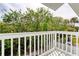 View from a patio overlooking lush green foliage and a small seating area at 721 Laurel Bay Cir, New Smyrna Beach, FL 32169