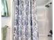 Close-up of the shower showcasing a decorative paisley shower curtain at 721 Laurel Bay Cir, New Smyrna Beach, FL 32169