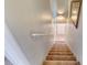 Carpeted staircase featuring a handrail and overhead lighting to the upper level at 721 Laurel Bay Cir, New Smyrna Beach, FL 32169