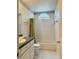 Bright bathroom featuring a tub and shower combination and decorative wallpaper border at 733 E Ohio Ave, Deland, FL 32724