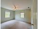 Light-filled bedroom featuring two windows and carpeted floors at 733 E Ohio Ave, Deland, FL 32724