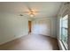 Well-lit bedroom showcasing carpeted floors, a ceiling fan, and closet space at 733 E Ohio Ave, Deland, FL 32724