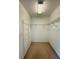 Walk-in closet features built-in metal shelving and neutral carpet at 733 E Ohio Ave, Deland, FL 32724