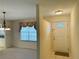 View of the front door and entry area, with tile flooring, adjacent to the dining room at 733 E Ohio Ave, Deland, FL 32724