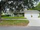 Charming home with a two-car garage, well-maintained lawn, and sidewalk access at 733 E Ohio Ave, Deland, FL 32724