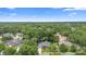 Aerial shot of a beautiful single-Gathering home surrounded by dense green trees in a quiet neighborhood at 802 Royal Oak Ct, Deland, FL 32724