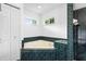 Bathroom features a bathtub with green tile, a corner window, and a double-door linen closet at 802 Royal Oak Ct, Deland, FL 32724