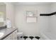 Bathroom featuring black and white tile, gray countertops, and window at 802 Royal Oak Ct, Deland, FL 32724