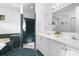 Bright bathroom features dual sinks, walk-in shower, soaking tub, and dark green tile floor at 802 Royal Oak Ct, Deland, FL 32724