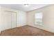Vacant bedroom has a window, neutral walls, and a closet for your belongings at 802 Royal Oak Ct, Deland, FL 32724