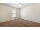 Vacant bedroom with brown carpet, window, and ceiling fan is ready for new occupants at 802 Royal Oak Ct, Deland, FL 32724