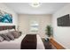 Bedroom with hardwood floors, a modern chandelier, and a large window for natural light at 802 Royal Oak Ct, Deland, FL 32724
