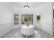 Bright dining room features a round table and large windows at 802 Royal Oak Ct, Deland, FL 32724