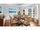 Bright dining room featuring a wooden table, six chairs, and large windows with elegant curtains at 802 Royal Oak Ct, Deland, FL 32724