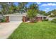Charming one-story brick home with a well-maintained front lawn and a two-car garage on a sunny day at 802 Royal Oak Ct, Deland, FL 32724