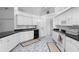 This kitchen offers white cabinetry, marble tile flooring and black countertops at 802 Royal Oak Ct, Deland, FL 32724