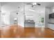 Open-concept living area with laminate flooring, a modern ceiling fan, and views of the kitchen and dining space at 802 Royal Oak Ct, Deland, FL 32724