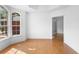 Bright room with laminate flooring, a large arched window, and white walls that create a clean and modern space at 802 Royal Oak Ct, Deland, FL 32724