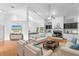 Inviting living room with neutral tones, fireplace, sofas, and a view to the kitchen at 802 Royal Oak Ct, Deland, FL 32724