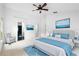 Bright main bedroom with modern decor, ocean art, plush bed, and ensuite bath at 802 Royal Oak Ct, Deland, FL 32724