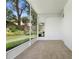 Enclosed lanai with tiled floors overlooks the green backyard at 802 Royal Oak Ct, Deland, FL 32724