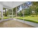 Relaxing screened porch with tile flooring and views of the lush, green backyard at 802 Royal Oak Ct, Deland, FL 32724
