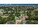 An aerial view shows the home in a neighborhood with mature trees, close to a body of water, and some with backyard pools at 833 Lucerne Cir, Ormond Beach, FL 32174