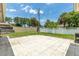 Spacious backyard features a concrete patio, lush lawn, and a white privacy fence at 833 Lucerne Cir, Ormond Beach, FL 32174